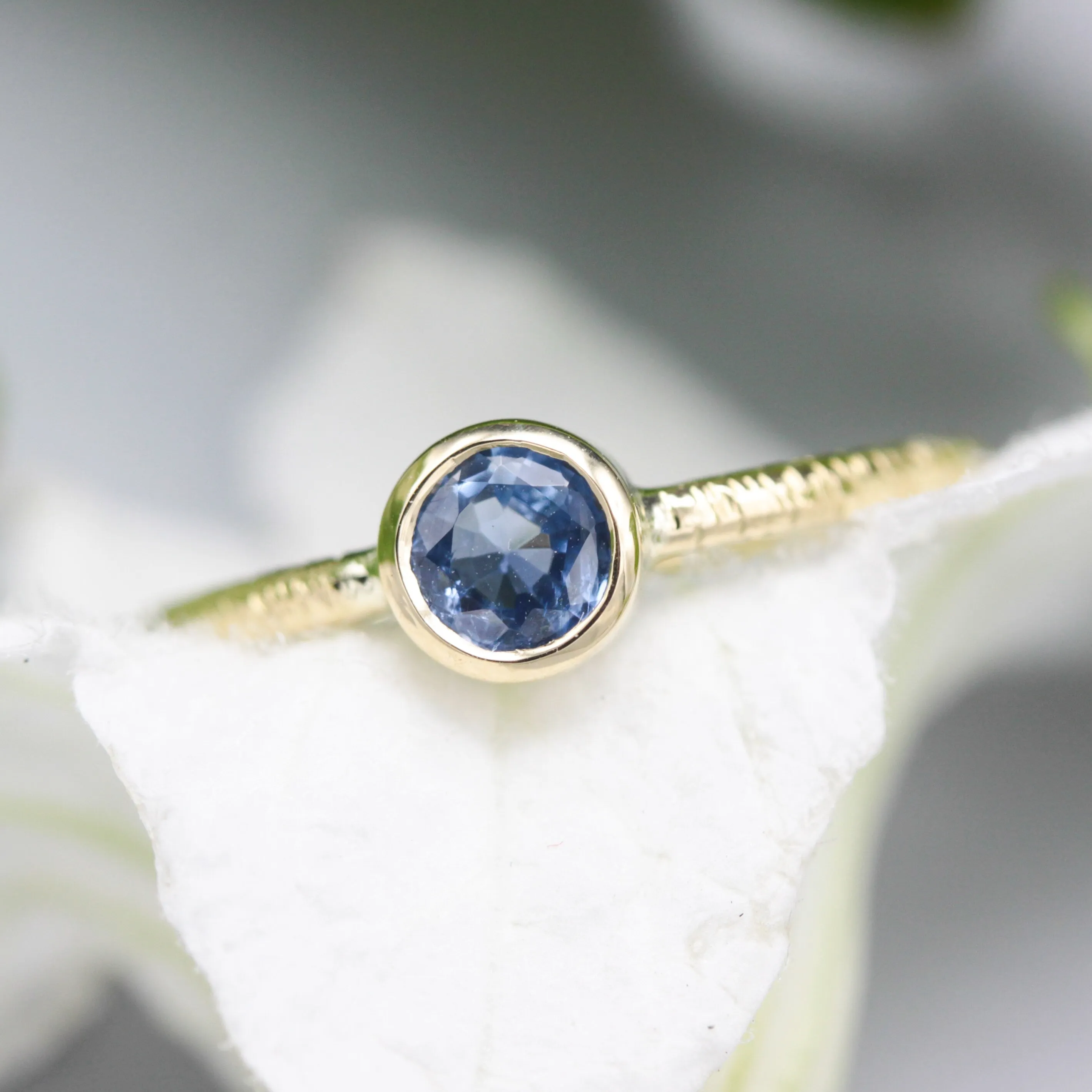 Round cut Blue sapphire ring in bezel settings with 18k gold texture band
