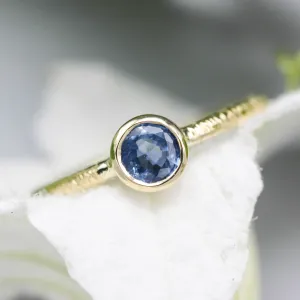 Round cut Blue sapphire ring in bezel settings with 18k gold texture band