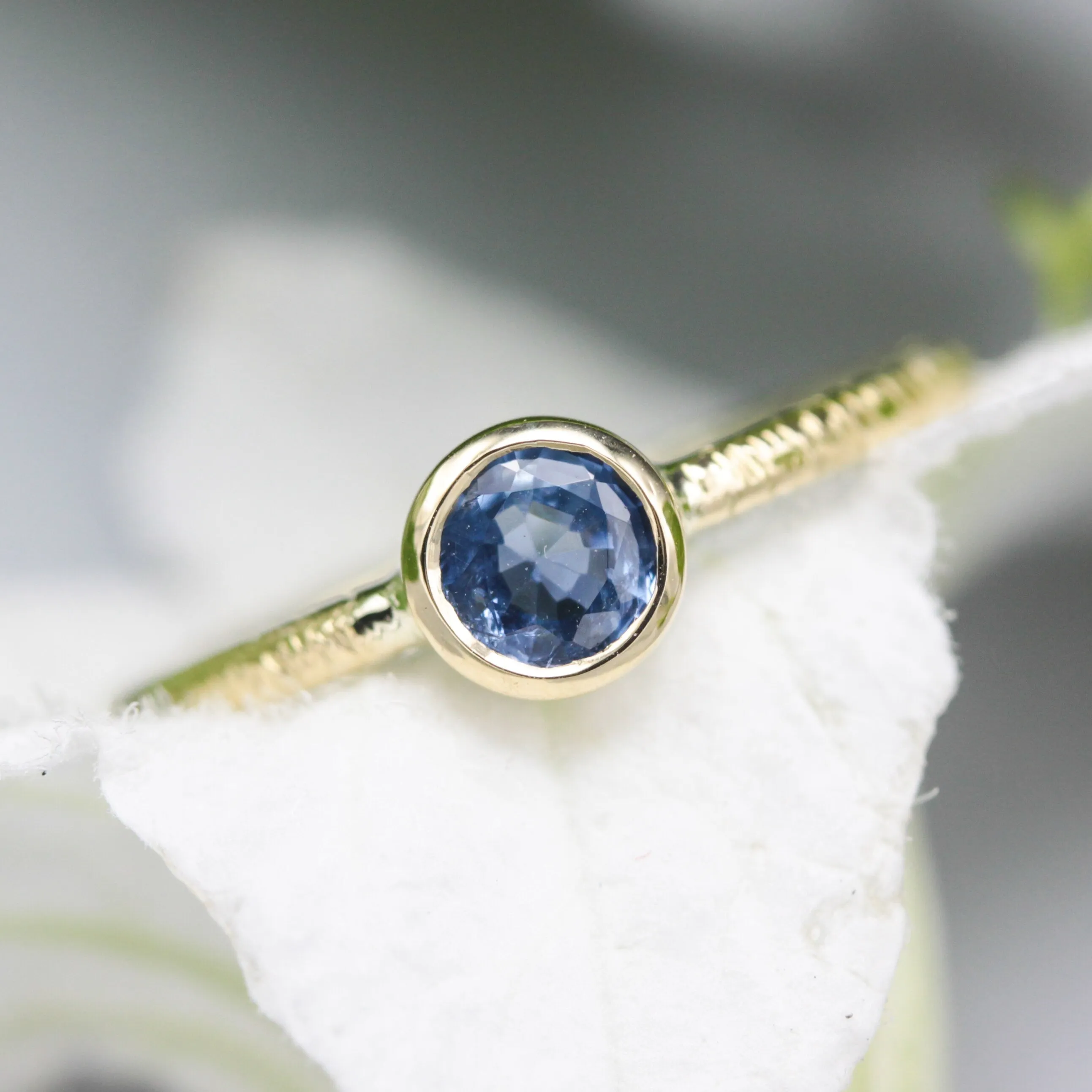Round cut Blue sapphire ring in bezel settings with 18k gold texture band