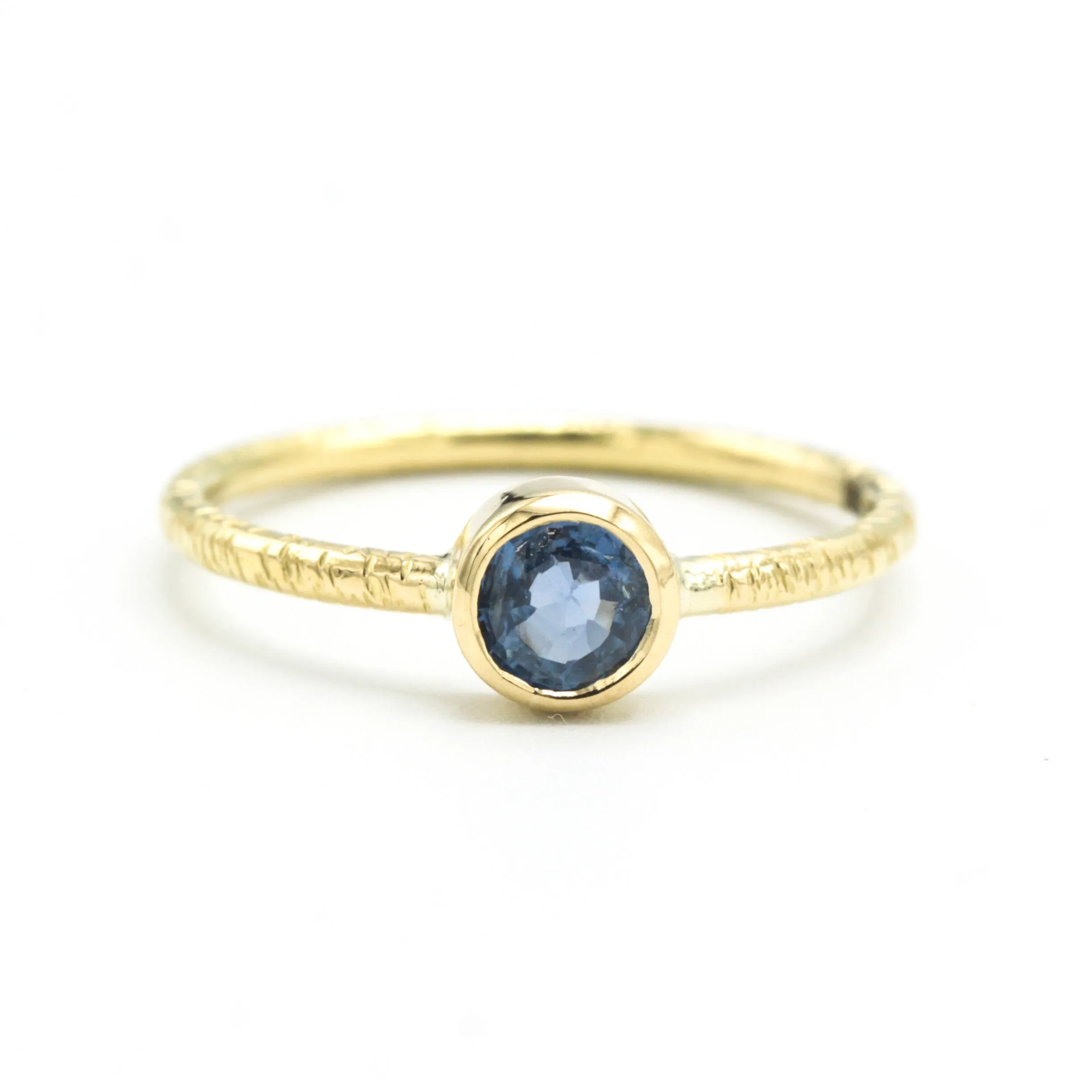 Round cut Blue sapphire ring in bezel settings with 18k gold texture band